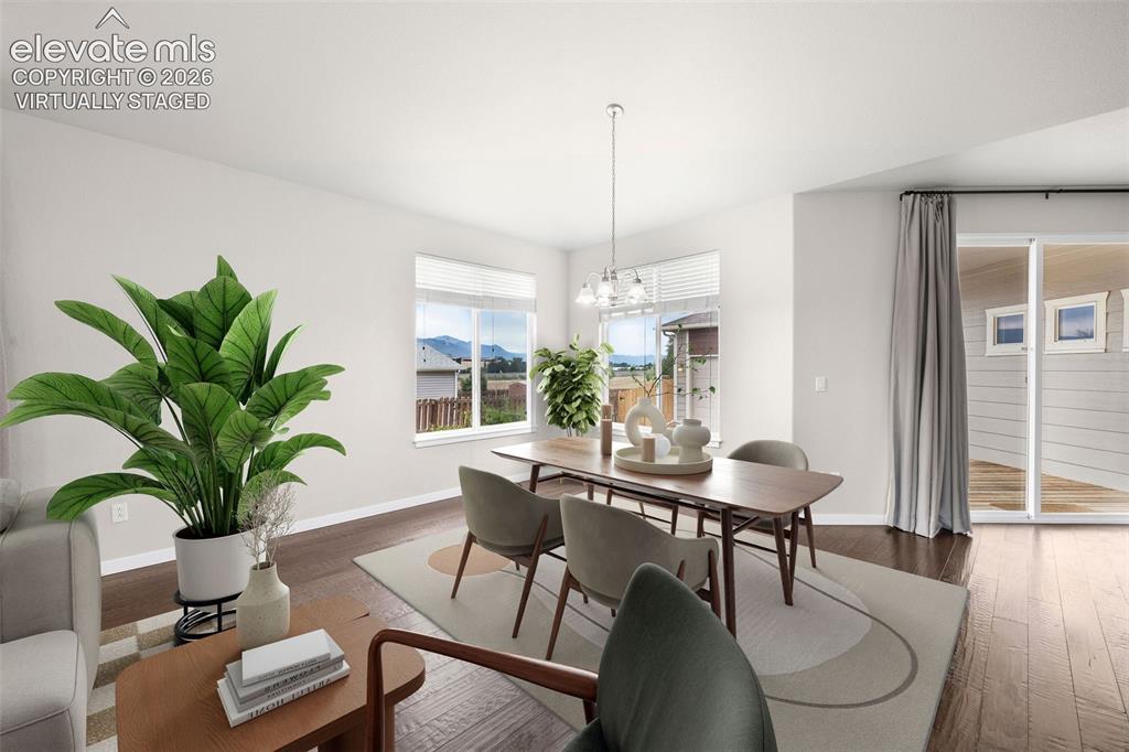 Image 13 of 39: Open-concept kitchen featuring rich dark wood cabinetry, a spacious center 