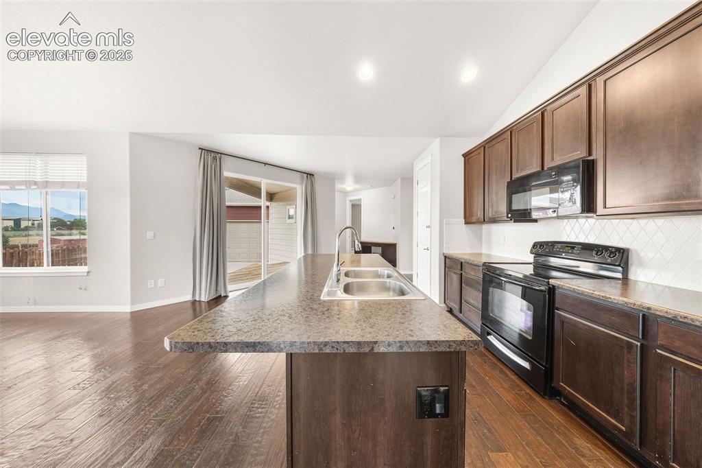 Image 16 of 39: Spacious primary bedroom featuring plush carpeting, a beautiful bay window,