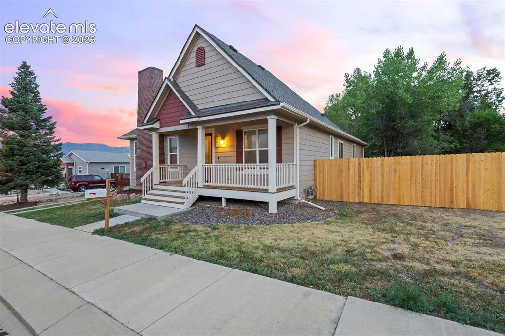 Image 36 of 39: Front exterior showcasing charming curb appeal and a brand-new 6-foot priva