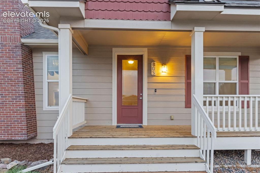 Image 4 of 39: Welcoming entryway featuring engineered wood flooring, a glass-paneled fron