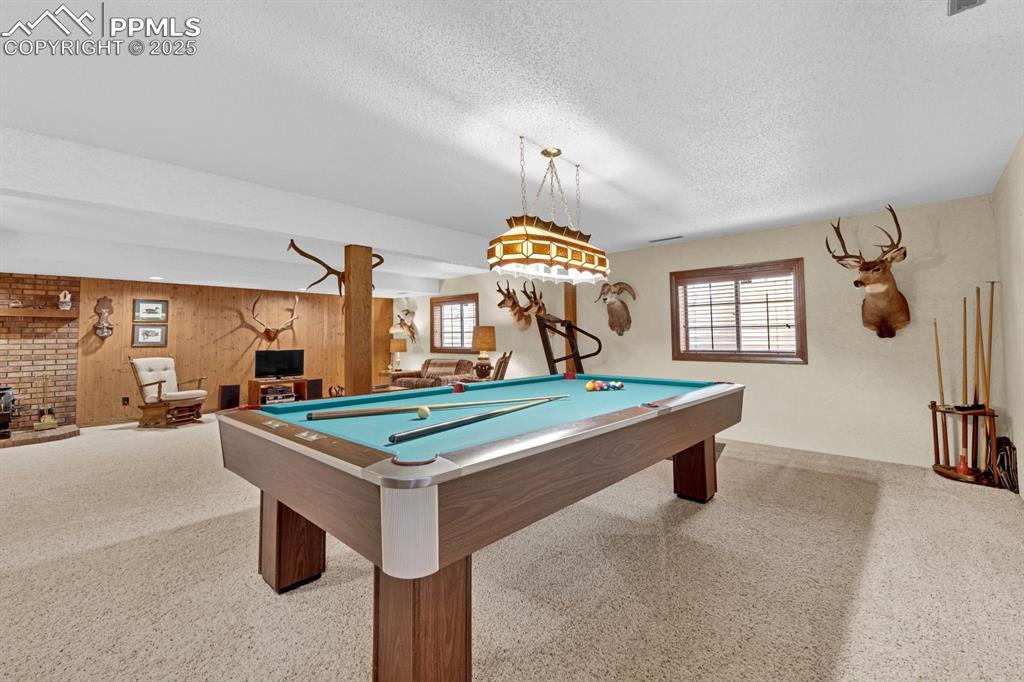 Image 26 of 47: Recreation room featuring pine wood paneling 