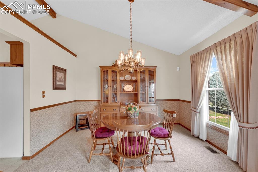 Image 8 of 47: Dining area with a wainscoted wall