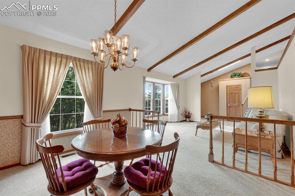 Image 9 of 47: Dining room featuring a chandelier and light carpet