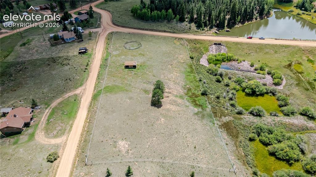 Image 20 of 35: Expansive land parcel featuring natural terrain and a distant body of water