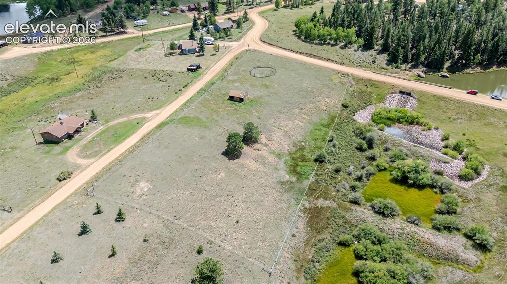 Image 21 of 35: Acreage with natural ground cover and adjacent water features.