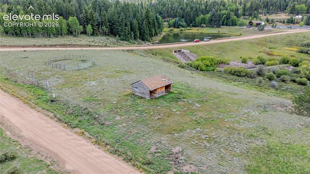 Image 24 of 35: Fully fenced lot with horse stall, corral and Lost Dutchman Resort across t
