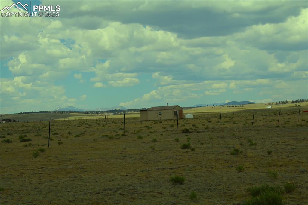 Caption: View of yard with a rural view and a mountain view
