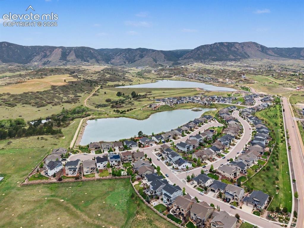 Image 12 of 44: Residential development featuring varied home styles, curved streets, and m