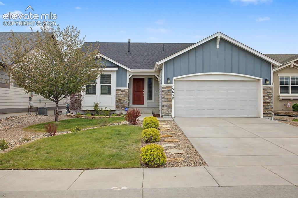 Image 15 of 44: Ranch-style residence featuring a combination of blue siding and stone vene