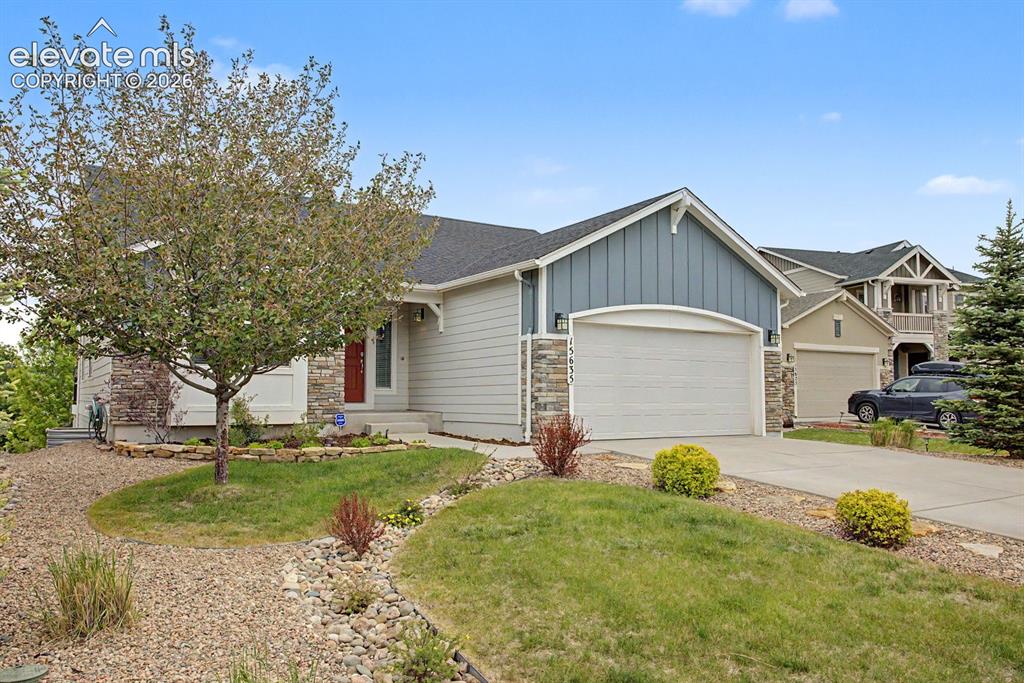 Image 16 of 44: Contemporary ranch-style home featuring a two-car garage, stone veneer acce