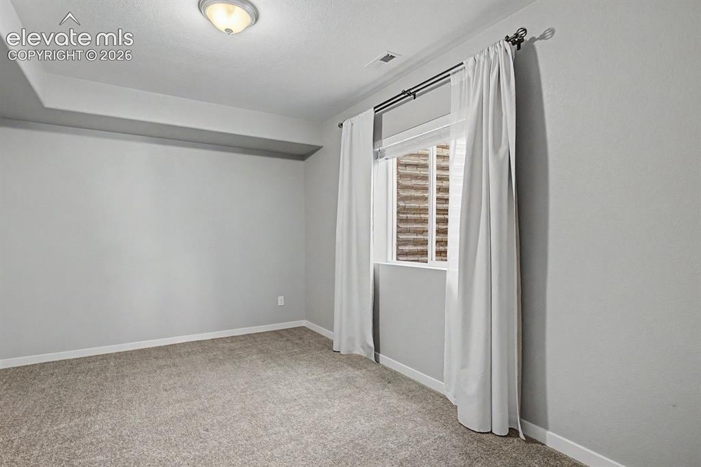 Image 33 of 44: Carpeted room featuring a drop ceiling, white trim, a flush mount ceiling l