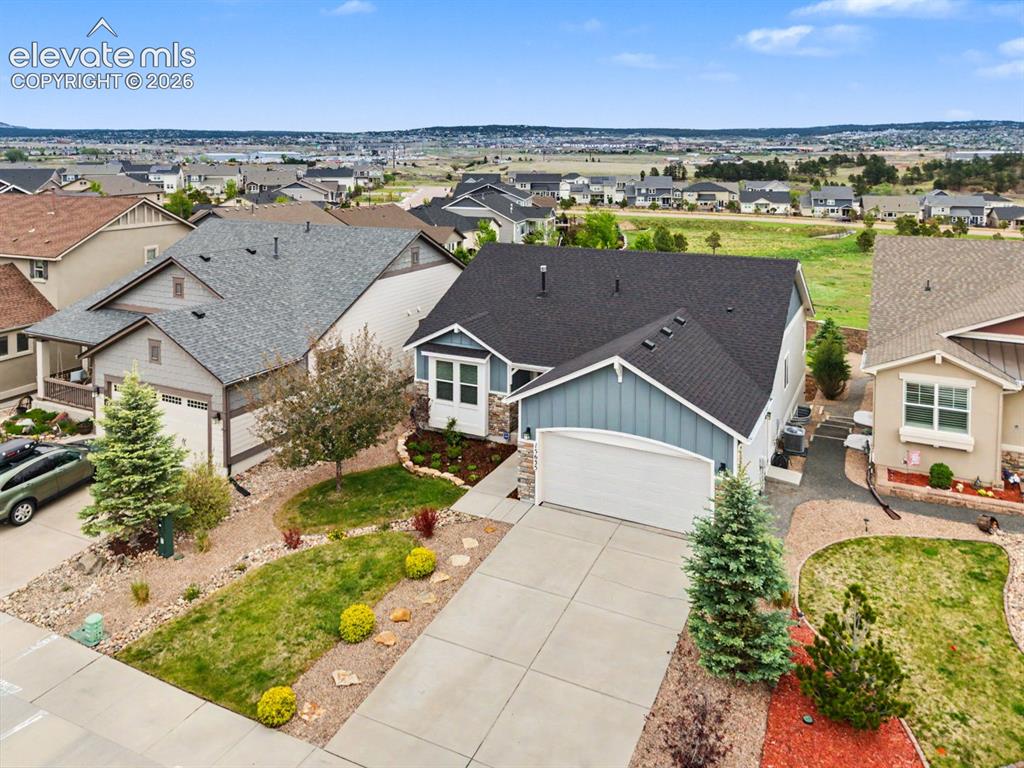 Image 39 of 44: Contemporary single-story residence featuring a two-car garage and a landsc