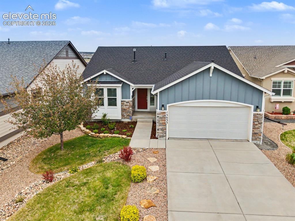 Image 41 of 44: Contemporary home with a two-car garage, stone accents, and a distinctive b