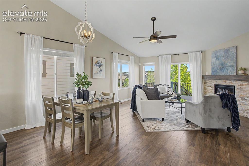 Image 6 of 44: Open-concept living space featuring wood-finish flooring, a vaulted ceiling