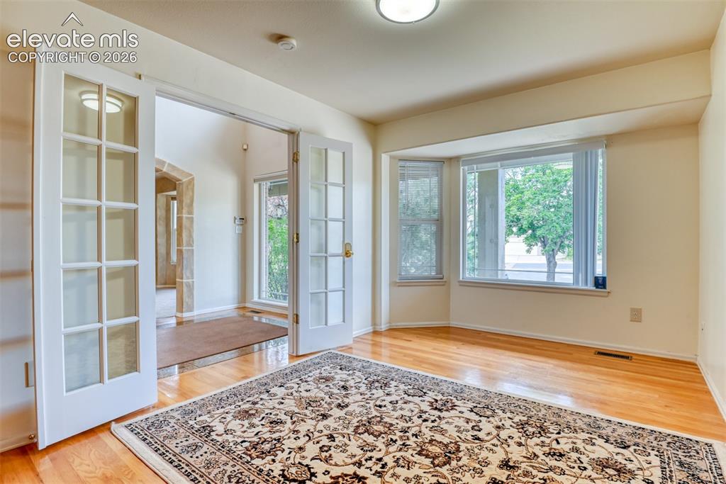 Image 11 of 50: Room with French door and built in shelving