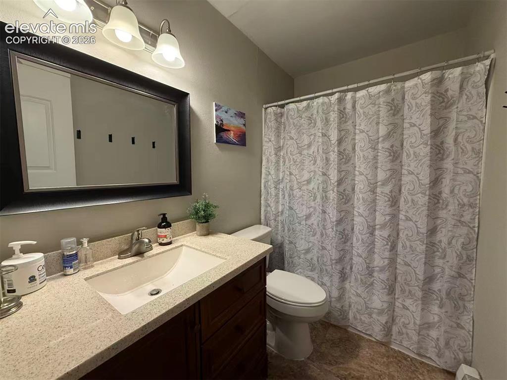 Image 7 of 11: Vanity with a light-colored countertop, an undermount sink, and a framed mi