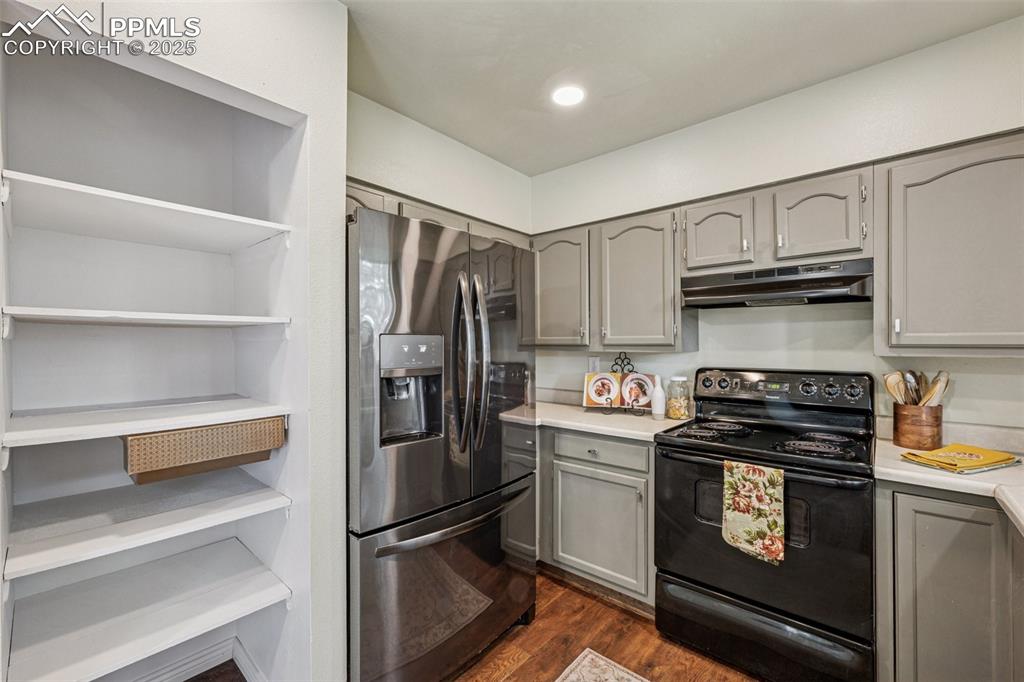 Image 14 of 44: Kitchen view of pantry and newer fridge