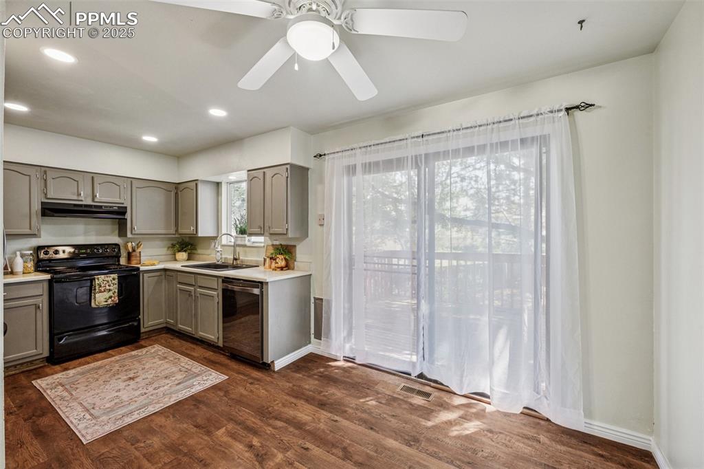 Image 17 of 44: View of kitchen and dining area and slider to deck