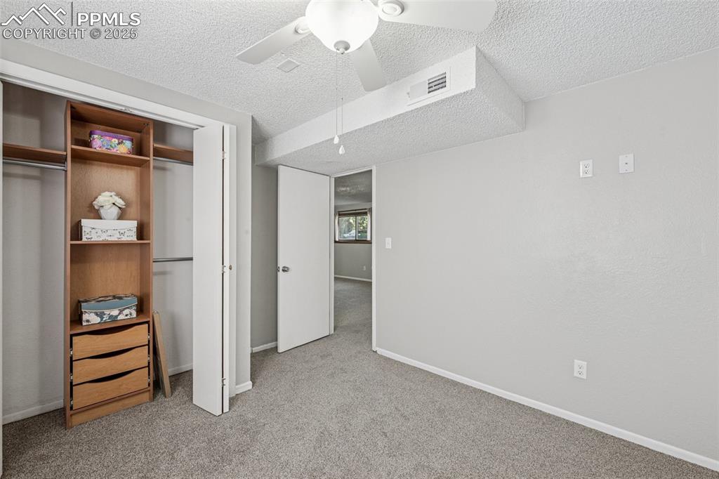 Image 31 of 44: second lower level bedroom, closet built ins, garden level window with good