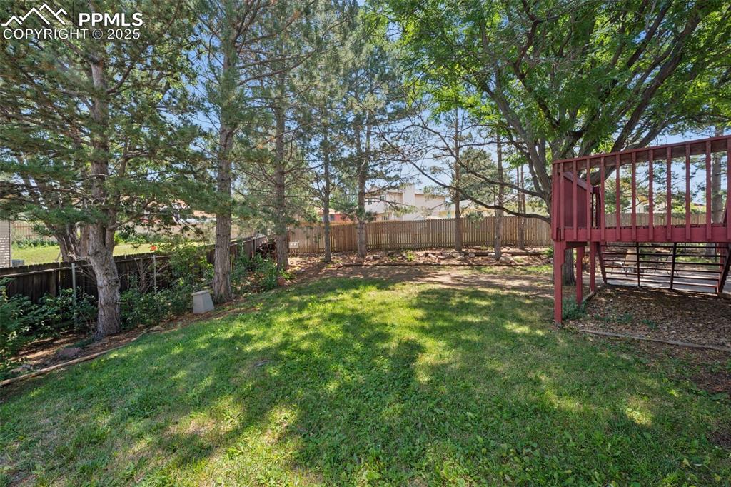Image 38 of 44: view of yard and established trees enhancing the tranquility of the yard