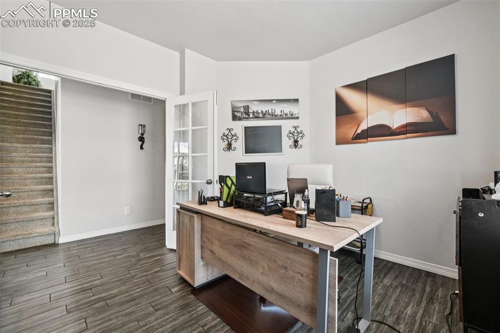 Image 19 of 44: Home office featuring dark wood-style floors