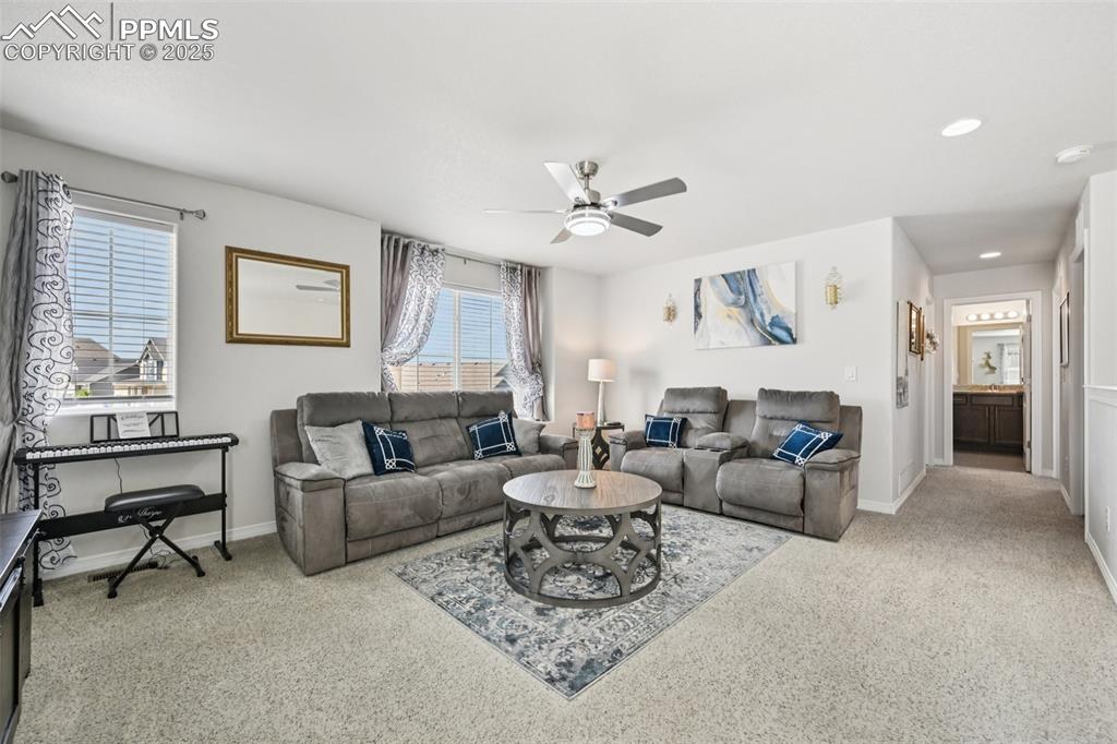 Image 21 of 44: Living room featuring ceiling fan, carpet floors, and recessed lighting