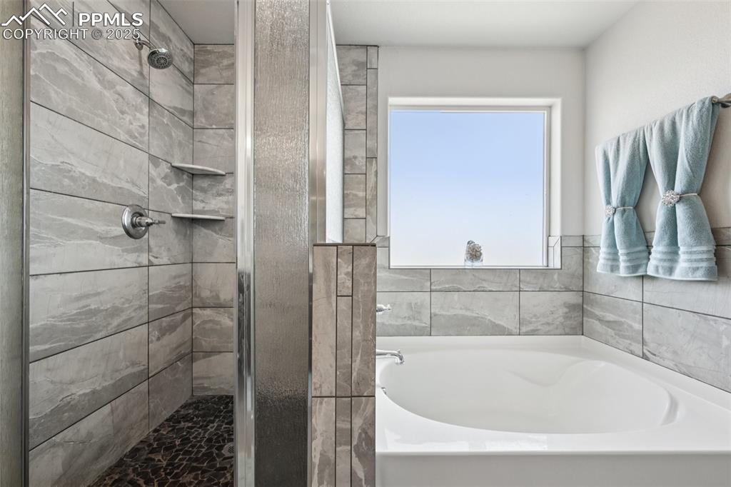 Image 28 of 44: Full bath featuring a shower stall and a bath