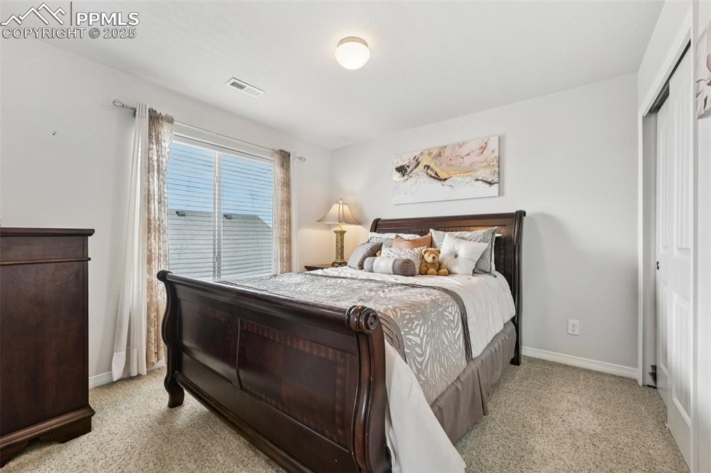 Image 30 of 44: Bedroom with light carpet and a closet