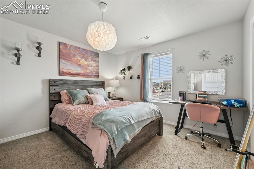 Image 32 of 44: Carpeted bedroom featuring baseboards and an office area