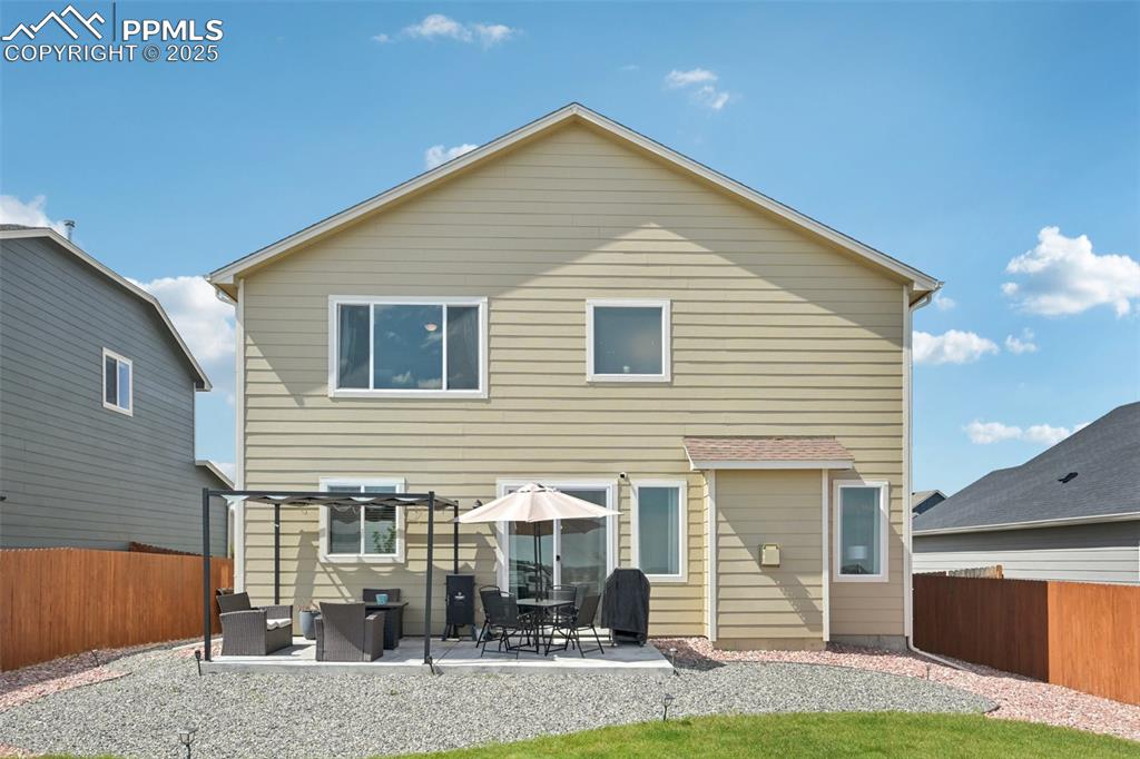 Image 38 of 44: Rear view of property featuring a fenced backyard and a patio area