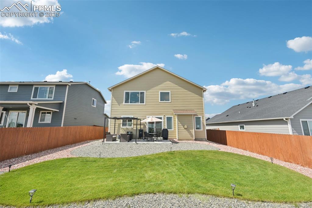 Image 39 of 44: Rear view of property featuring a patio area and a fenced backyard