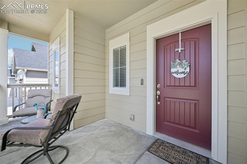 Image 5 of 44: Doorway to property with covered porch