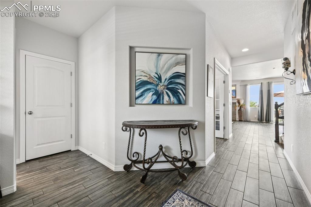 Image 7 of 44: Hall featuring dark wood-style flooring and recessed lighting