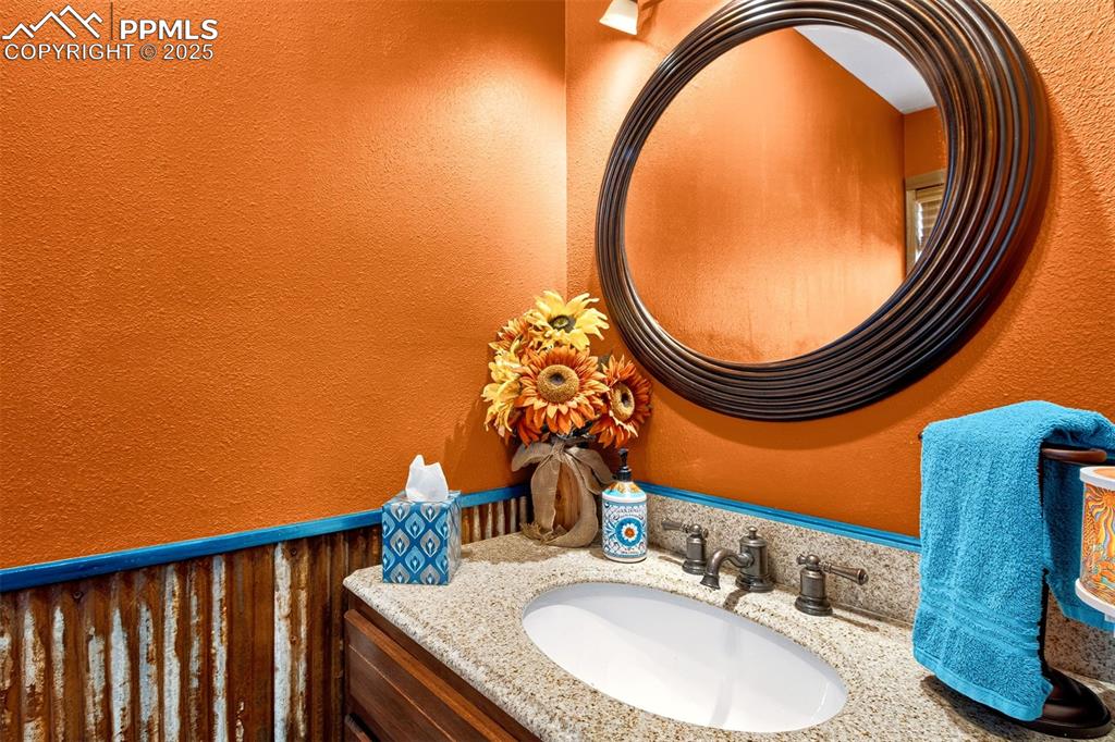 Image 18 of 42: Bathroom featuring a textured wall and vanity