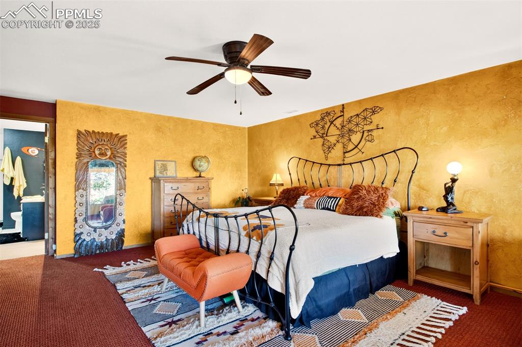 Image 21 of 42: Carpeted bedroom with a ceiling fan and baseboards