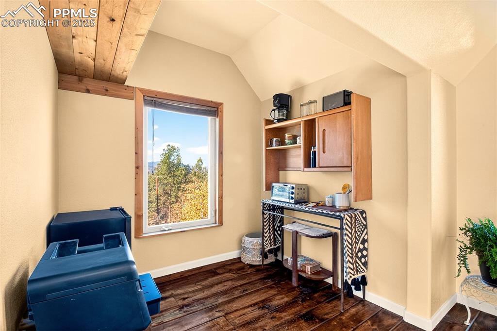 Image 30 of 42: Home office featuring dark wood-type flooring and vaulted ceiling