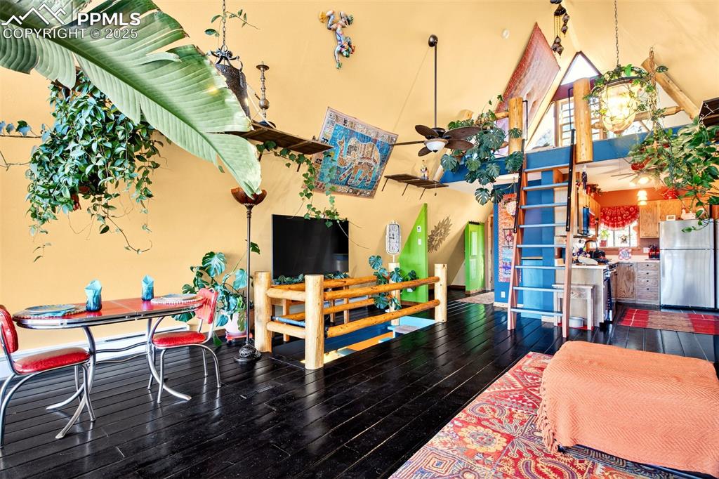 Image 8 of 42: Recreation room with high vaulted ceiling and hardwood / wood-style floors