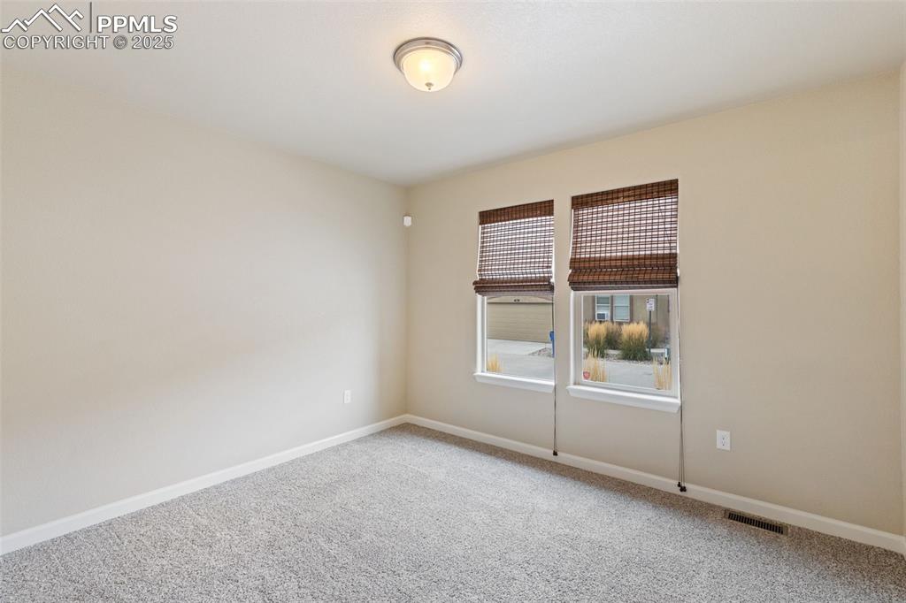 Image 15 of 33: Carpeted spare room with baseboards