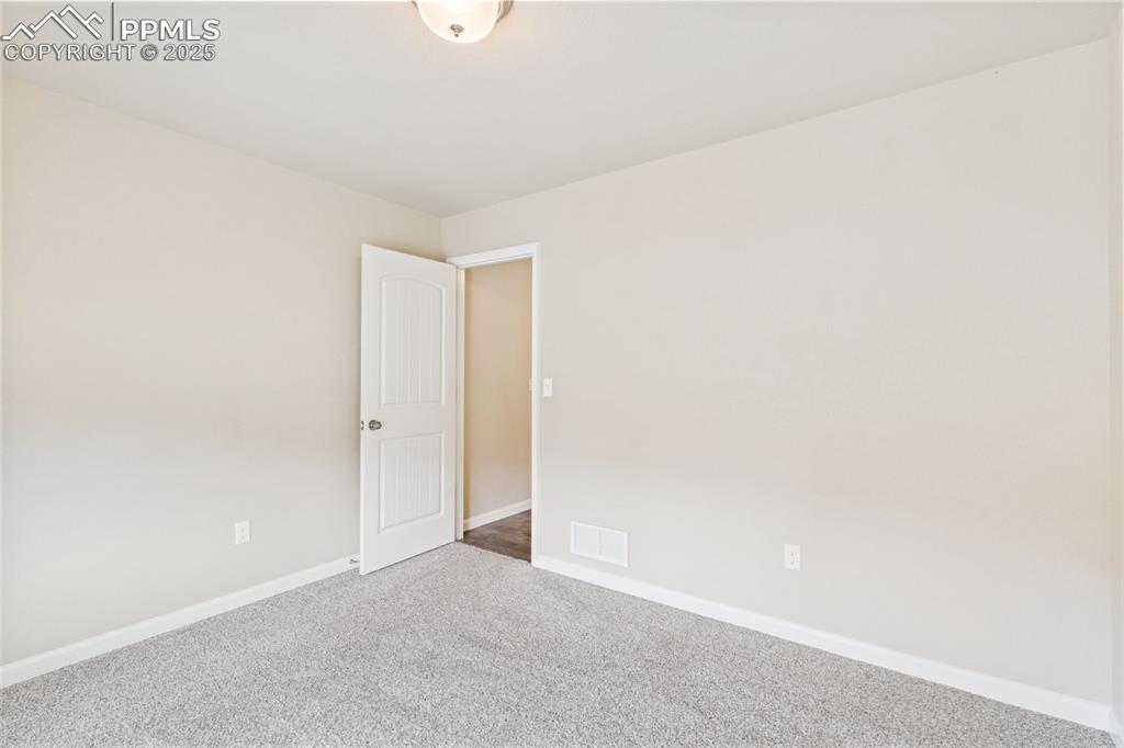 Image 16 of 33: Empty room featuring carpet flooring and baseboards