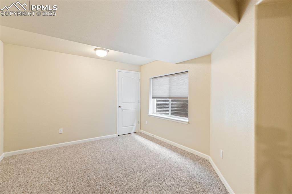 Image 17 of 33: Carpeted empty room featuring baseboards