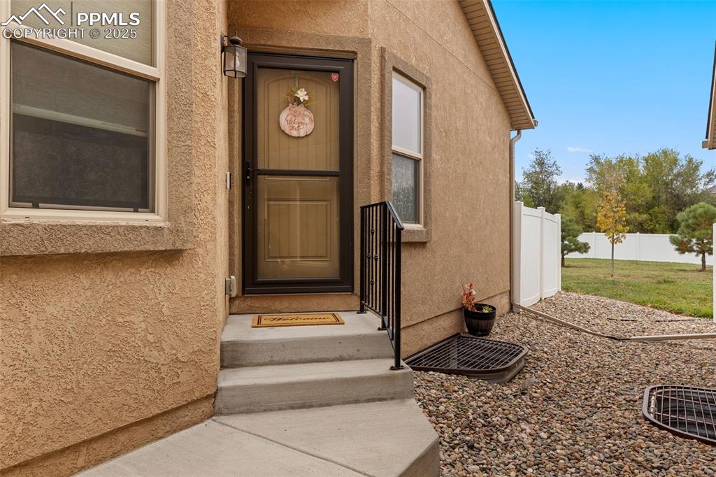 Image 2 of 33: View of exterior entry with stucco siding