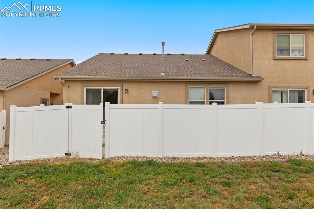 Image 33 of 33: View of property exterior with stucco siding, roof with shingles, and a gat