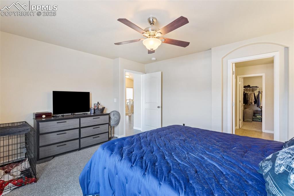 Image 9 of 33: Bedroom with carpet floors and a ceiling fan