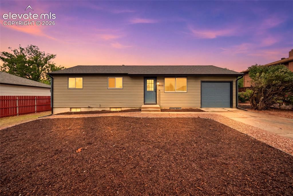 Image 1 of 26: Ranch-style exterior with horizontal siding, an attached garage, a paved dr