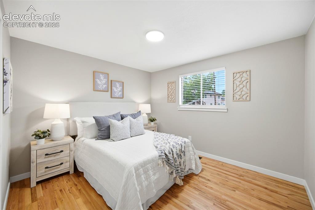 Image 11 of 26: Hardwood-style flooring with a window offering natural illumination