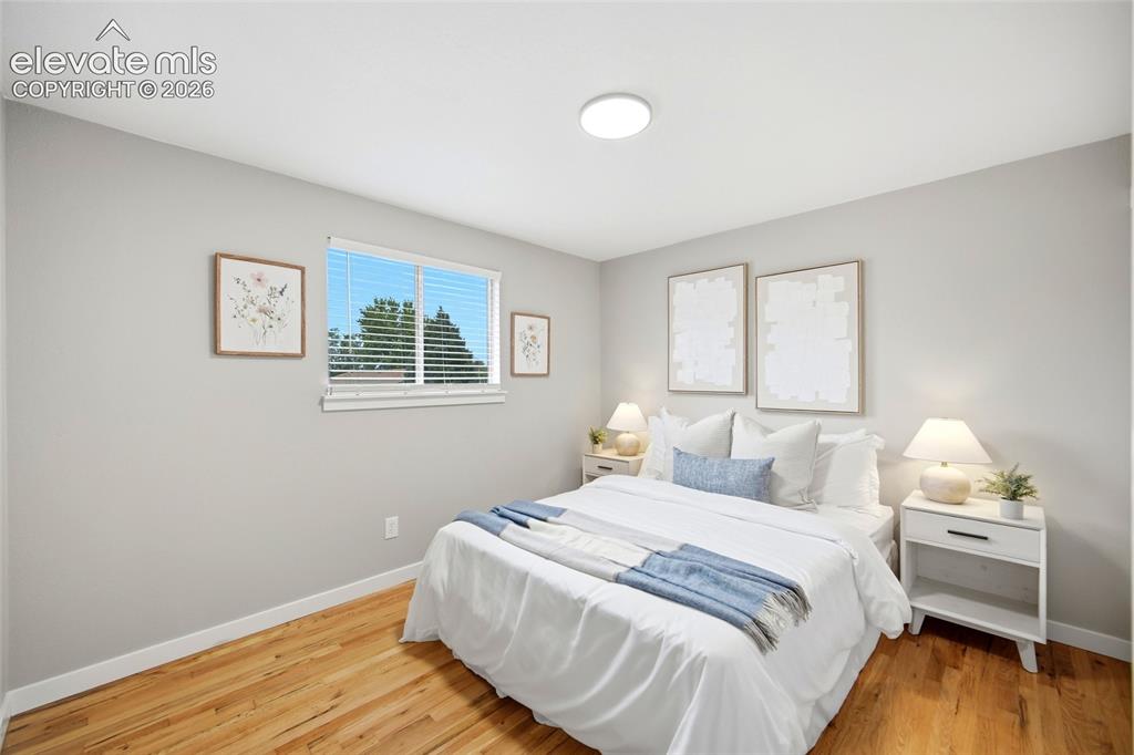 Image 13 of 26: Recessed lighting, wood-finish flooring, and light gray wall paint