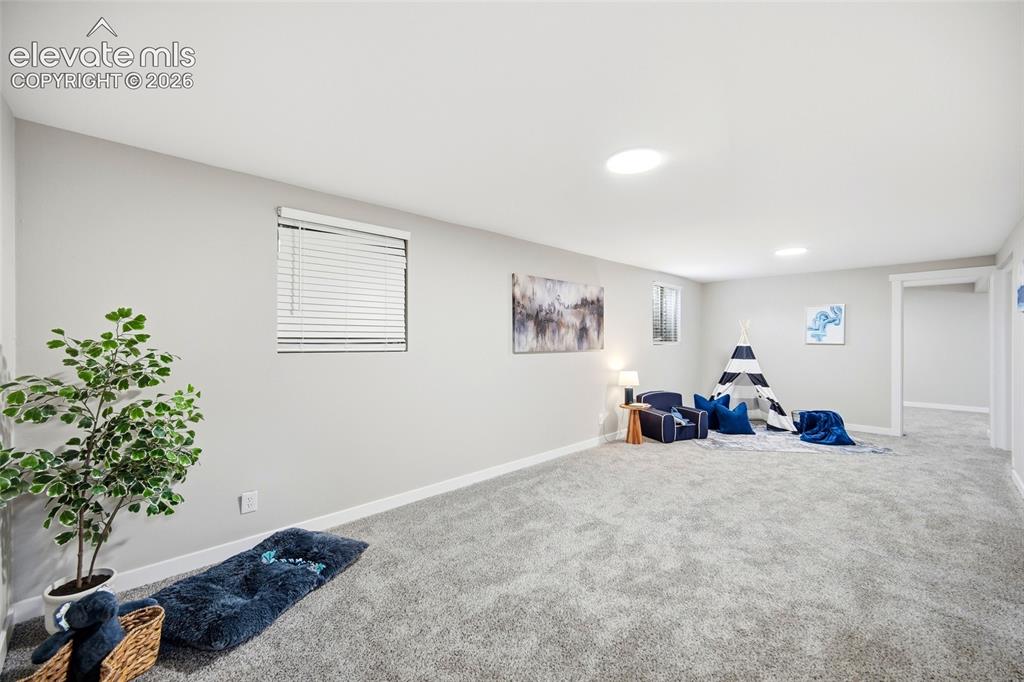Image 15 of 26: Expansive carpeted room featuring light gray walls, multiple recessed ceili