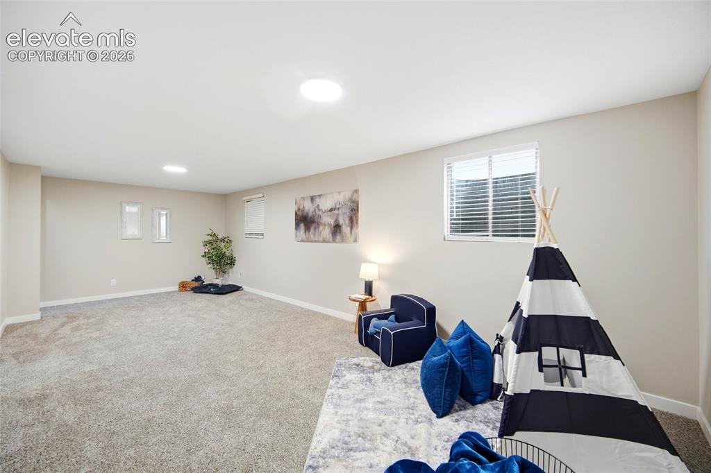 Image 19 of 26: Spacious room featuring neutral carpeting, light-colored walls, recessed li