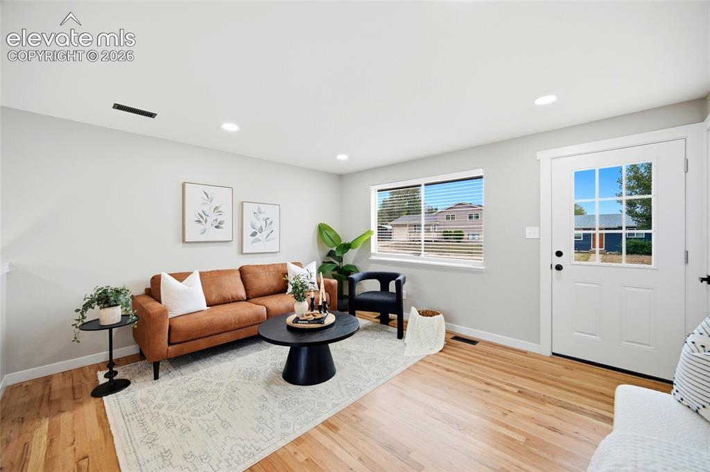 Image 4 of 26: Hardwood flooring complements light gray walls