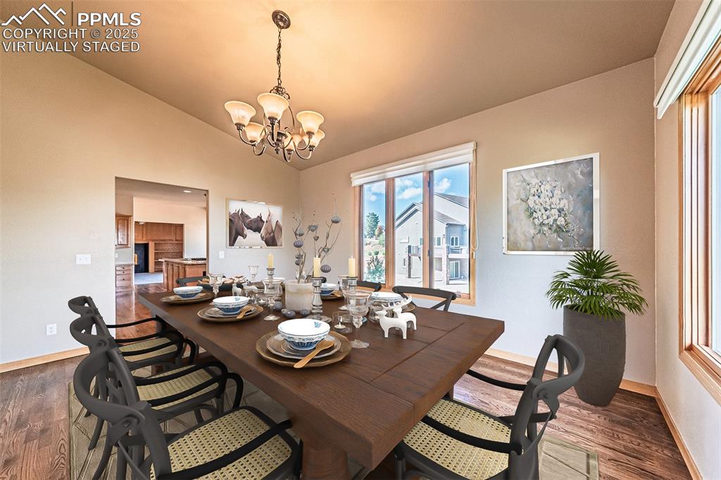 Image 14 of 45: Virtually Staged
Dining room with dark wood finished floors, vaulted ceili